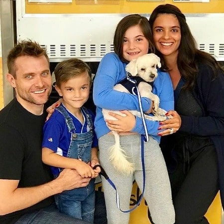 Picture of Neil Hopkins with his wife Saba Homayoon, children and pet dog